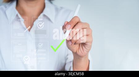 Businesswoman marking checklist for approval, audit and quality validation process. Concept of compliance management, task completion, document verifi Stock Photo
