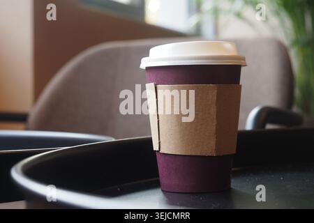 Coffee cup on a table in a cozy cafe environment Stock Photo