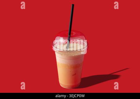 Fresh Strawberry Smoothie Drink in Plastic Cup with Mint on Blue Background Stock Photo