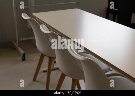 Modern classroom interior with empty desks and chairs before lesson Stock Photo