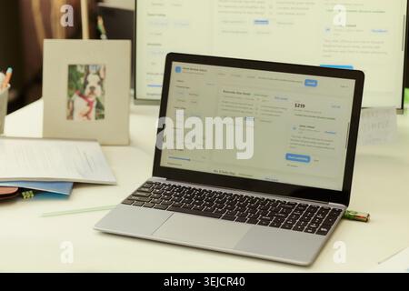 Close up of laptop displaying hotel booking platform on office desk, showing travel planning and online reservation workflow. Ideal for tourism marketing, booking app promotion Stock Photo