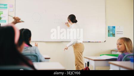 Students, teacher or woman with writing on whiteboard, addition lesson or math syllabus for learning. Teaching, education or educator with class for Stock Photo