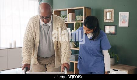 Healthcare, mobility and walker of old man with nurse in clinic for balance or rehabilitation. Help, stability and walking frame of senior patient Stock Photo