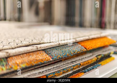 Close up of layered decorative carpet samples in flooring and home improvement store Stock Photo
