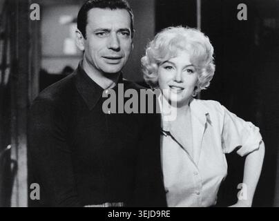 Yves Montand (1921–1991) and Marilyn Monroe (1926–1962) in Hollywood, California, 1960. They starred in the musical Let's Make Love, the penultimate completed film for Monroe, an icon of the Golden Age, and the American debut for Montand. Stock Photo