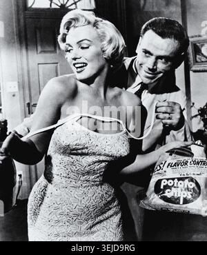 Marilyn Monroe (1926–1962) and Tom Ewell (1909–1994) in Hollywood, California, 1955. Pictured in a scene from The Seven Year Itch, the actress received a BAFTA nomination for Best Foreign Actress for her performance in this 20th Century-Fox hit. Stock Photo