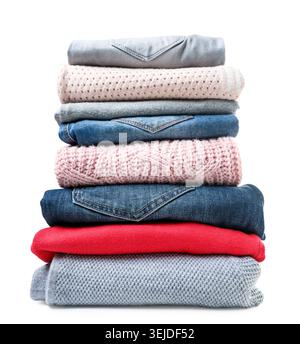 Stack of clothes sweaters and jeans close-up on a white background. Isolated Stock Photo