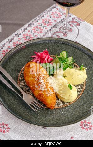 Plated Chicken Kyiv with mashed potatoes and wine Stock Photo