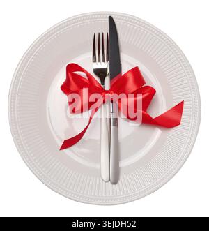 Empty white round plate, fork and knife on isolated background Stock Photo