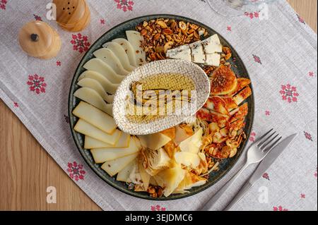 Gourmet cheese platter with assorted nuts and honey Stock Photo