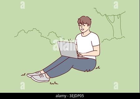 Smiling man sit in park work on laptop Stock Photo
