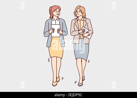 Businesswomen walk talking in office Stock Photo
