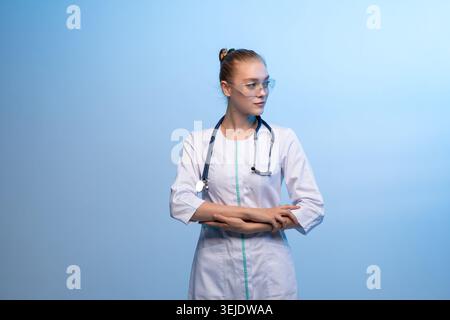 Medical professional wearing safety glasses and stethoscope Stock Photo