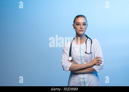 Female doctor wearing safety glasses and stethoscope posing Stock Photo