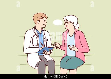 Elderly woman with doctor sit on couch complaining to hospital employee about health problems Stock Photo
