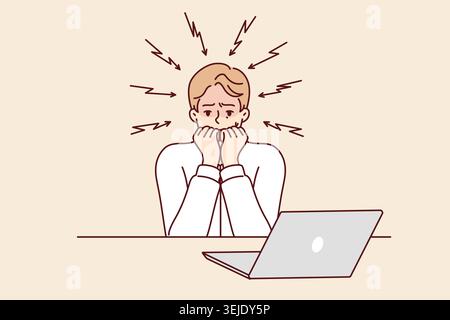 Frightened man bites nails after reading news on laptop about approaching unemployment or recession Stock Photo
