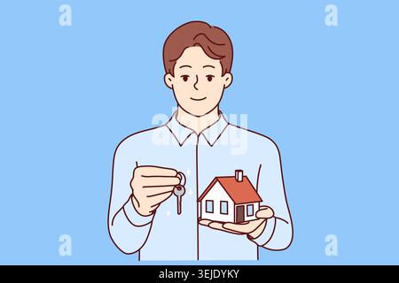 Man real estate broker holds keys and model house offering to take out mortgage on favorable terms Stock Photo