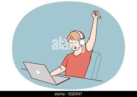 Delighted teen boy sitting at table with laptop playing video game and defeating virtual opponents Stock Photo