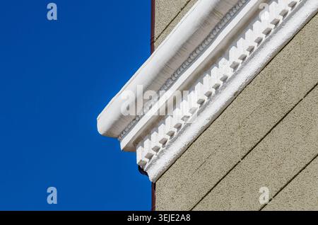 White stucco cornice on a light green plastered cinder block wall Stock Photo