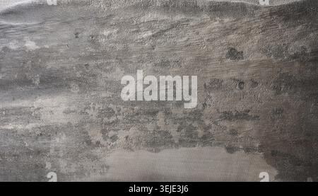 Close up of a worn and scratched metal surface with dark and light gray tones. Stock Photo
