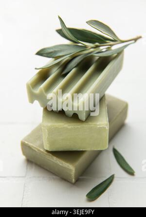 Olive soap bars forming a stack with olive branch on top Stock Photo