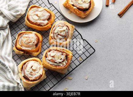 Freshly baked cinnamon rolls cooling on a wire rack Stock Photo