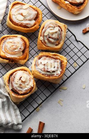 Freshly baked cinnamon rolls cooling on a wire rack Stock Photo