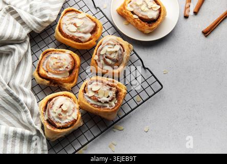 Freshly baked cinnamon rolls cooling on a wire rack Stock Photo