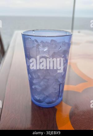 Crushed ice in a plastic cup close up. Blue transparent cold cup Stock Photo
