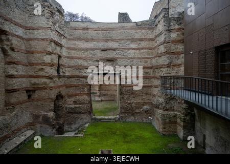 View of an ancient stone wall with brick courses and a doorway, part of the historic architecture at the Musée de Cluny in Paris, France. Stock Photo