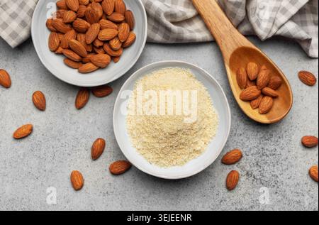Fresh almond flour in a  bowl and almonds Stock Photo