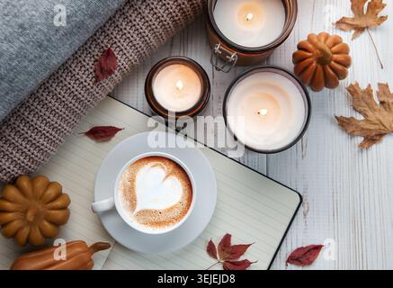 Autumn cozy composition. Autumn flat lay of coffee,cookies, fall leaves, candle on wooden white background.  Autumn, fall concep Stock Photo