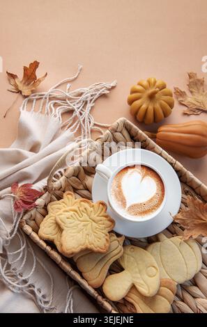 Cup of coffee, cookies on tray, yellow leaves. Stock Photo