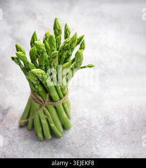 Fresh green asparagus on  concrete background. Stock Photo