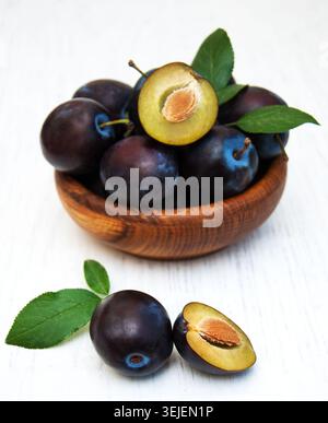 Sweet plums on a old wooden background; Stock Photo