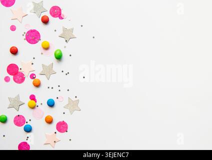 Happy birthday concept, confetti and multicolored candy  on a white background. flat lay, top view Stock Photo