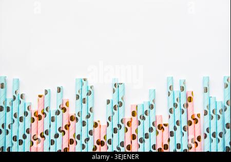 Drinking dotted straws for party  on white  background with copy space. Top view of colorful paper disposable eco-friendly straw Stock Photo