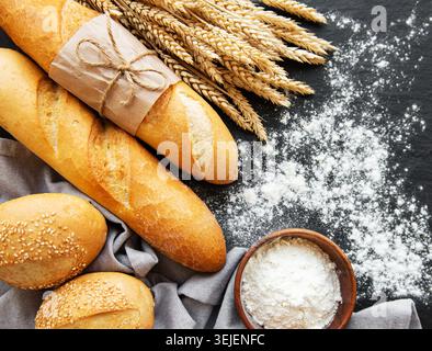 Assortment of baked bread on black concrete background Stock Photo