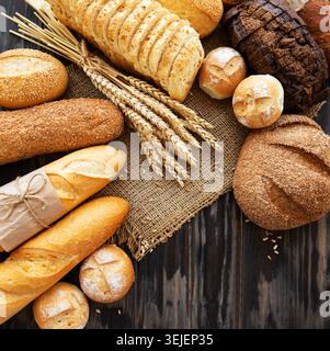 Assortment of baked bread on old wooden  background Stock Photo