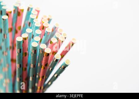 Drinking dotted straws for party  on white  background with copy space. Top view of colorful paper disposable eco-friendly straw Stock Photo