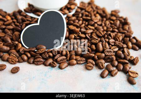 Coffee beans and card in the shape of a heart Stock Photo