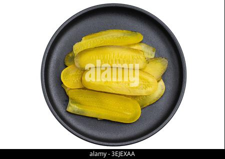 Fresh crunchy pickle slices stacked on a dark plate with white background, vibrant preserved cucumbers in top view Stock Photo