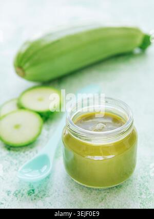 Jar with healthy baby food and zucchini Stock Photo