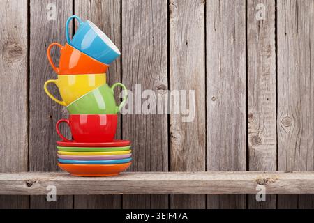 Colorful coffee cups on shelf Stock Photo
