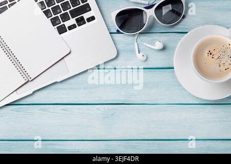 Desk table with laptop, coffee and sunglasses Stock Photo