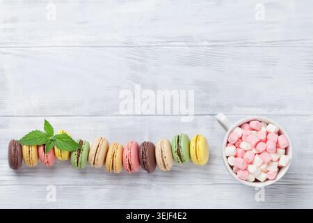 Colorful macaroons on wooden table Stock Photo