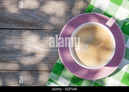 Coffee cup on garden table Stock Photo