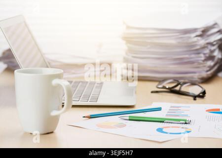 Office workplace with coffee, laptop and supplies Stock Photo