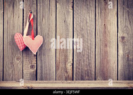 Two Valentines day hearts on rustic wooden wall Stock Photo
