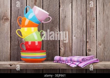 Colorful coffee cups on shelf Stock Photo